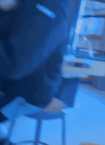 a blurred image of a person sitting at a table