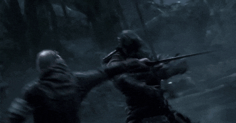 a samurai is fighting another samurai with a sword in the dark .