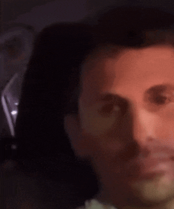 a blurry picture of a man 's face with a beard .
