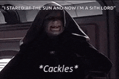 a man in a hooded cloak is pointing at the camera .