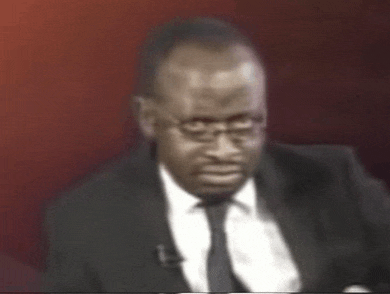 a man in a suit and tie with glasses on