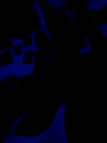 a dark room with a blue light shining on the wall