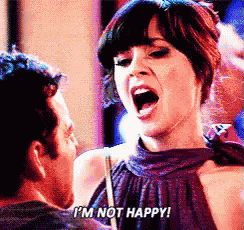 a woman in a purple dress says i 'm not happy in front of a man