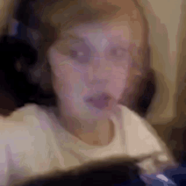 a blurry picture of a child playing a video game on a computer .