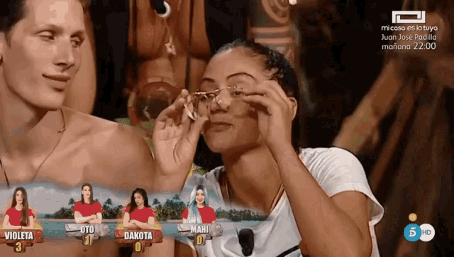 a woman wearing glasses looks at a man in front of a screen that says micasa es la tuya