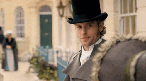 a man in a top hat is standing next to a horse