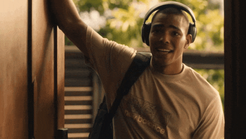 a man wearing headphones and a new balance t-shirt