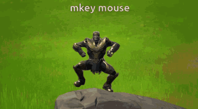 a statue of thanos is standing on top of a rock with the words mkey mouse above him