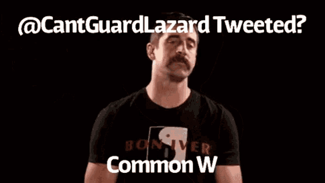 a man with a mustache is giving a thumbs up with a twitter logo behind him .
