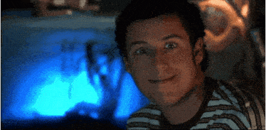 a close up of a man 's face with a blue background