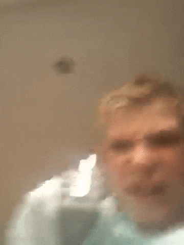 a blurry picture of a person 's face with a light behind them .