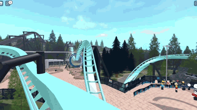 a roller coaster in a video game with a few people standing around it