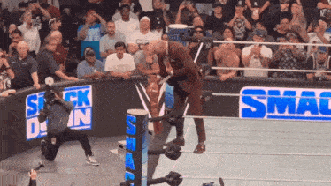 a wrestling ring with a sign that says smac