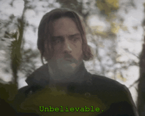 a man with a beard is standing in front of a sign that says " unbelievable "