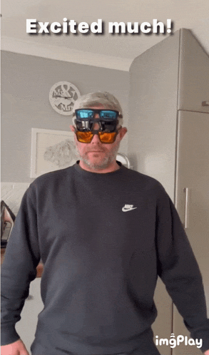 a man wearing sunglasses and a black nike shirt is excited