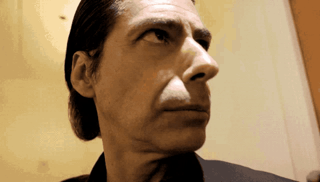 a close up of a man 's face with a very serious look on his face