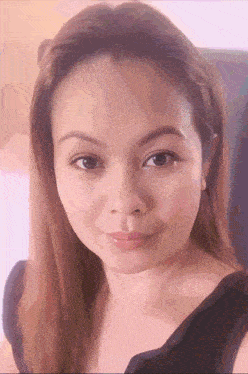 a close up of a woman 's face with a purple background