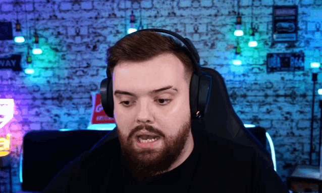 a man with a beard wearing headphones and a sign that says coca cola