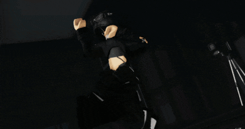 a girl in a black hoodie and headphones is covering her face