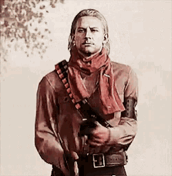 a man with a scarf around his neck is holding a gun ..