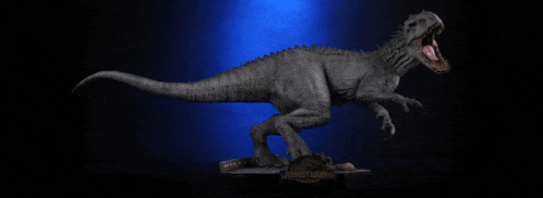 a statue of a dinosaur with the word jurassic world on it