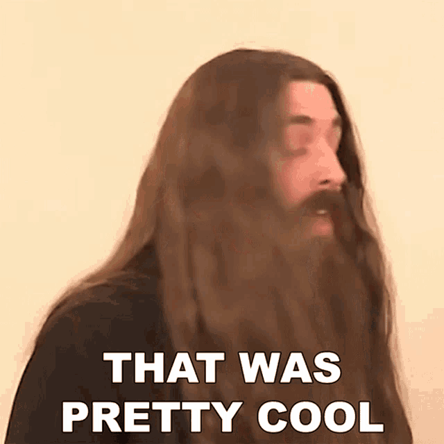a man with long hair and a beard has the words that was pretty cool below him