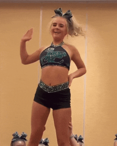 a cheerleader is wearing a top that says ' sdc ' on it