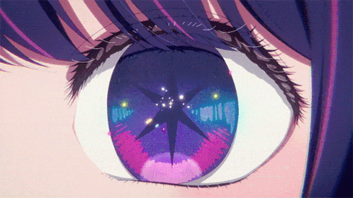a close up of a girl 's eye with a star reflection in it