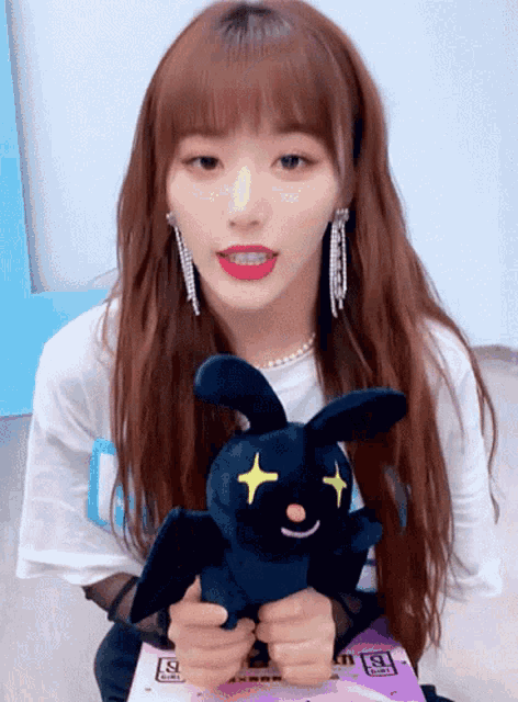 a girl holding a stuffed animal with the number 9 on the bottom
