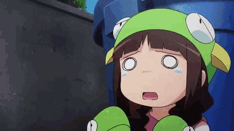 a girl wearing a green hat with a frog on it