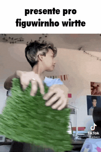 a tiktok video of a person holding a piece of green grass