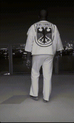 a man is wearing a shirt that says vultures on it