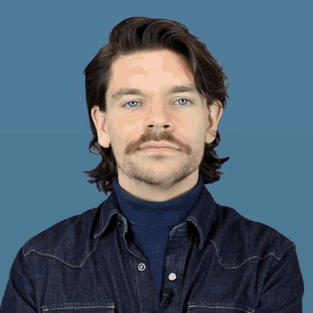 a man with a mustache says bye bye with his mouth open