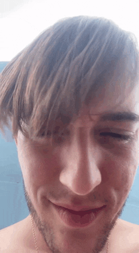 a close up of a man 's face with his eyes closed and a beard