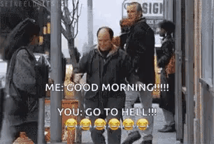 a man is walking down a street with a woman and a sign that says ' me good morning you go to hell ' .