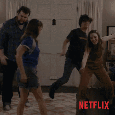 a group of people are dancing in a living room with a netflix logo in the background