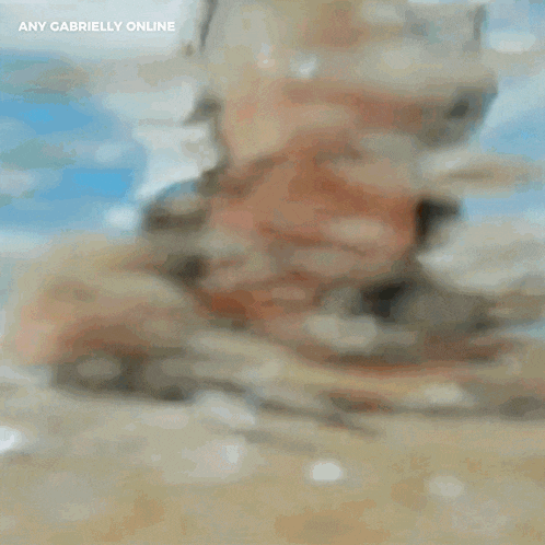 a blurry picture of a man 's face with the words any gabrielly online above it