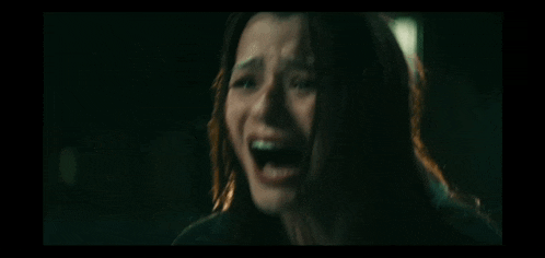 a close up of a woman screaming with her mouth open