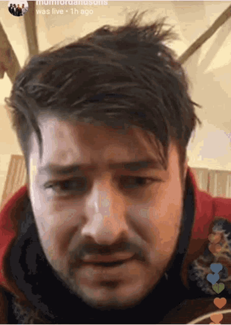 a close up of a man 's face with the words " was live " in the upper right corner