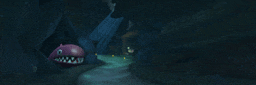 a cartoon character is swimming in a cave with a large mouth