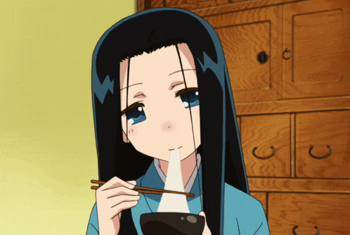 a girl with long black hair and blue eyes is eating something with chopsticks