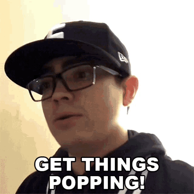 a man wearing glasses and a black hat says get things popping