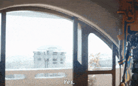 a person standing in front of a window with the word yes on it