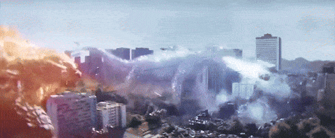 an aerial view of a city with buildings on fire and smoke coming out of it
