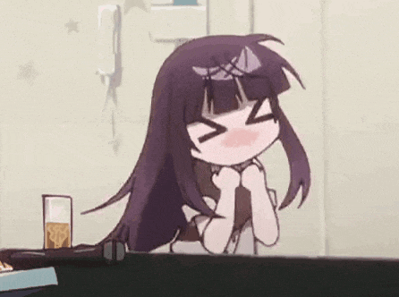 a girl with purple hair is sitting at a table with her eyes closed and her hands on her chin .