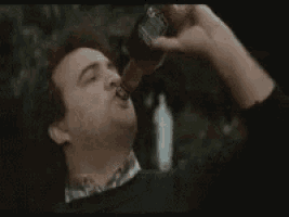 a man is drinking from a bottle of jack daniels whiskey