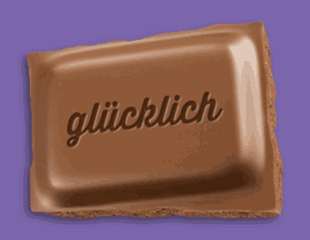 a piece of chocolate has the word glücklich written on it