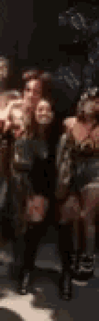 a blurry picture of a group of people sitting in a theater .