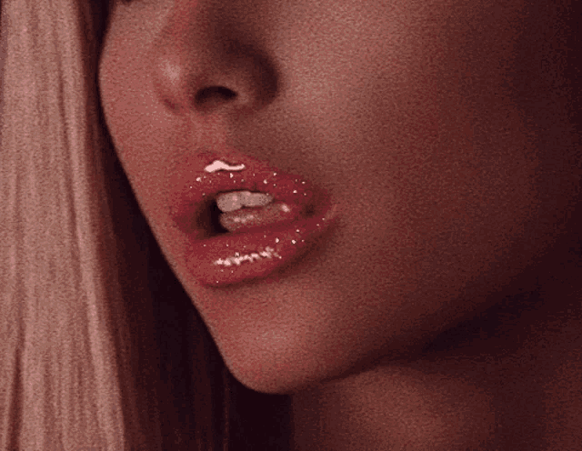 a close up of a woman 's mouth with red lipstick