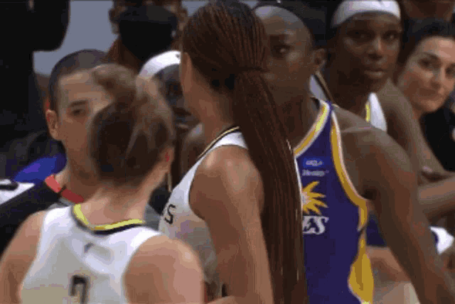 a female basketball player wearing a jersey that says ' lsu ' on it